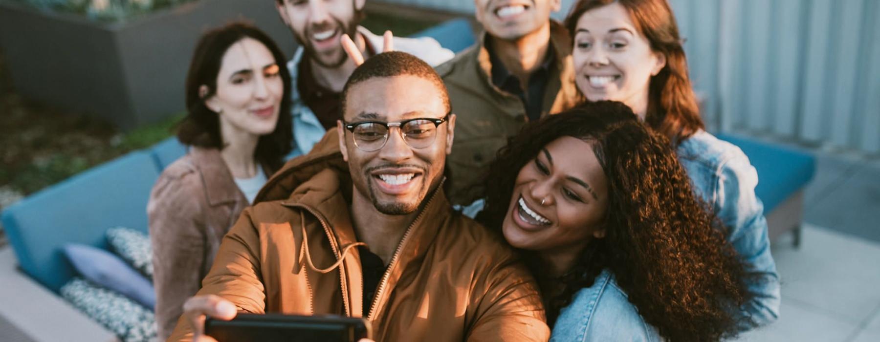 friends take a group selfie outdoors