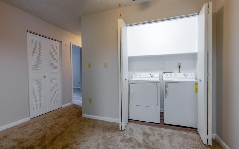 side-by-side washer/dryer units in closet