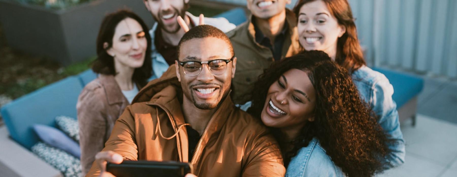 friends take a group selfie outdoors